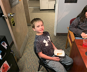 one male student eating a snack
