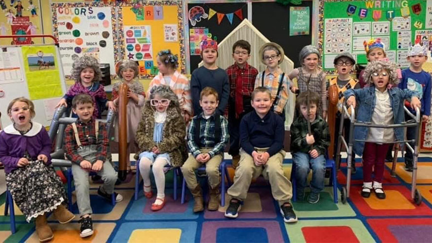 Students in grandma and grandpa costumes in class