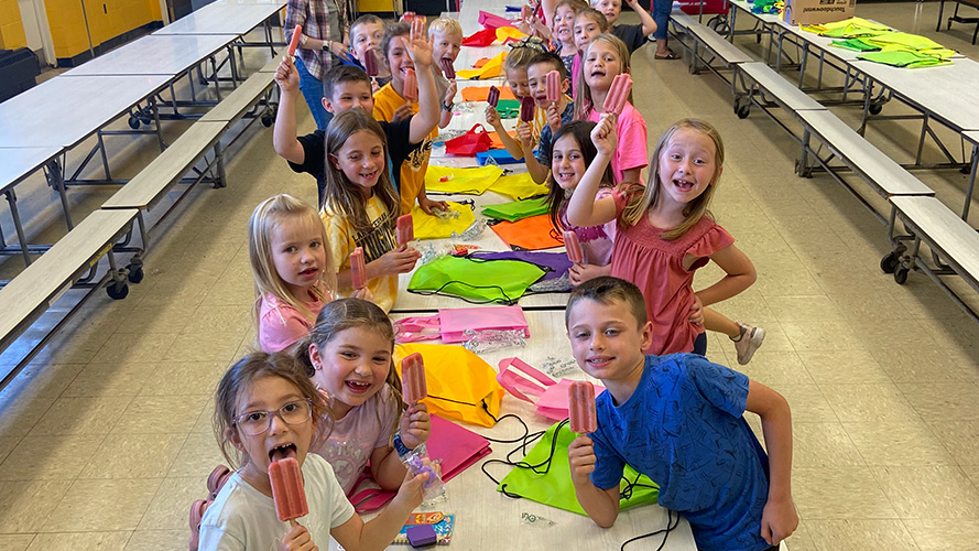 Students in cafeteria eating popsicles