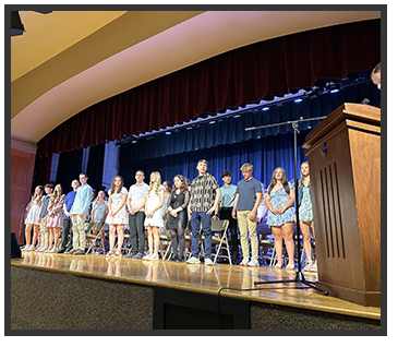 Students standing on stage
