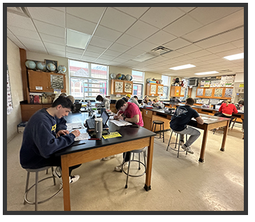 Students sitting at tables in a classroom