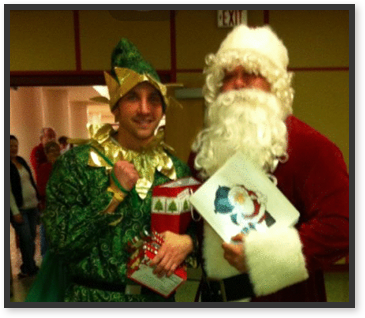 Staff members dressed as Santa Claus and an elf