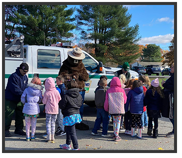 Students talking to rangers and Smokey Bear