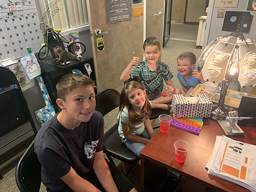 Group of students enjoying toast in the principal's office