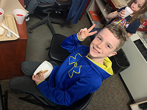 Little boy giving the peace sign while enjoying the Principal's Toast celebration