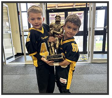 two students holding a trophy