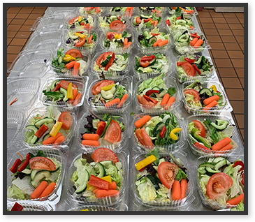 Beautiful salads lined up on table