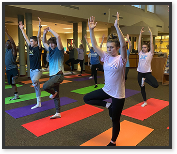 More students enjoying yoga activity