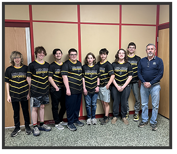students with matching shirts standing next to an adult