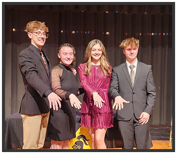 Students holding their hands out to show the camera their rings