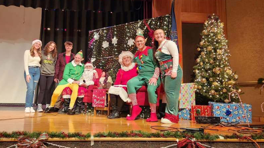 Students on a Christmas decorated stage