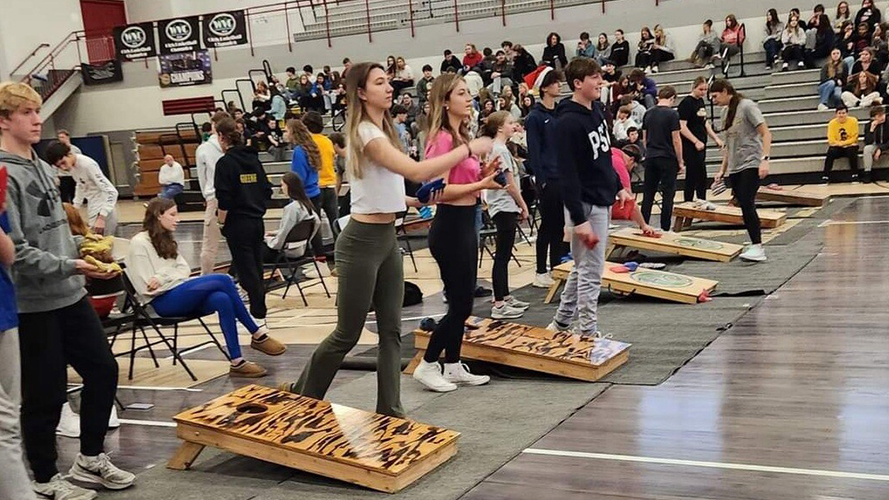 Students in the gym playing a tossing game
